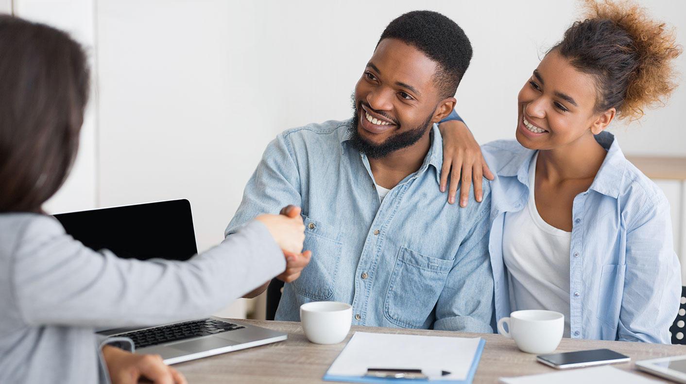 Young couple shaking hand with a woman