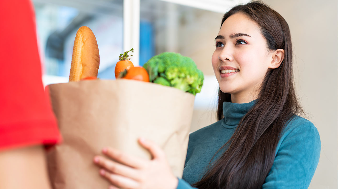 Young woman delivering grocery