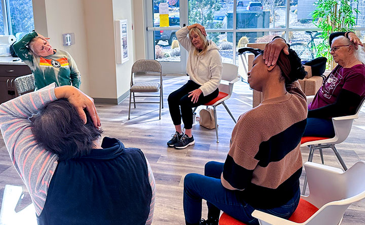 Residents at one of Cornerstone's managed properties doing chair yoga