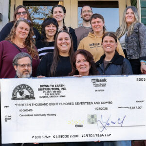 Down To Earth presing the fundraising check to